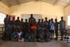 Students at Nkandanzovu Upper Basic pose with their math teacher.